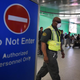 An airport worker wears a protective face mask in the arrivals area of Los Angeles International Airport as the U.S. announced increased passenger screenings against the Ebola virus on Oct. 9, 2014.
MARK RALSTON/AFP/Getty Images